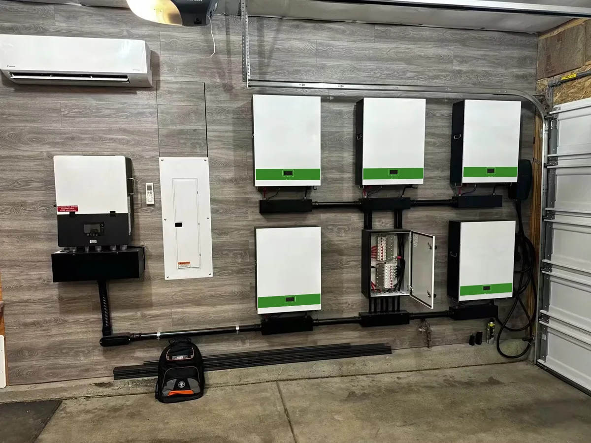 Residential side yard installation with white wall battery