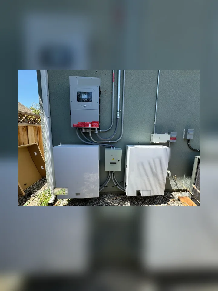 Off-grid LiFePO4 battery cabinets, inverter, DC combiner box, and conduit in a clean outdoor install