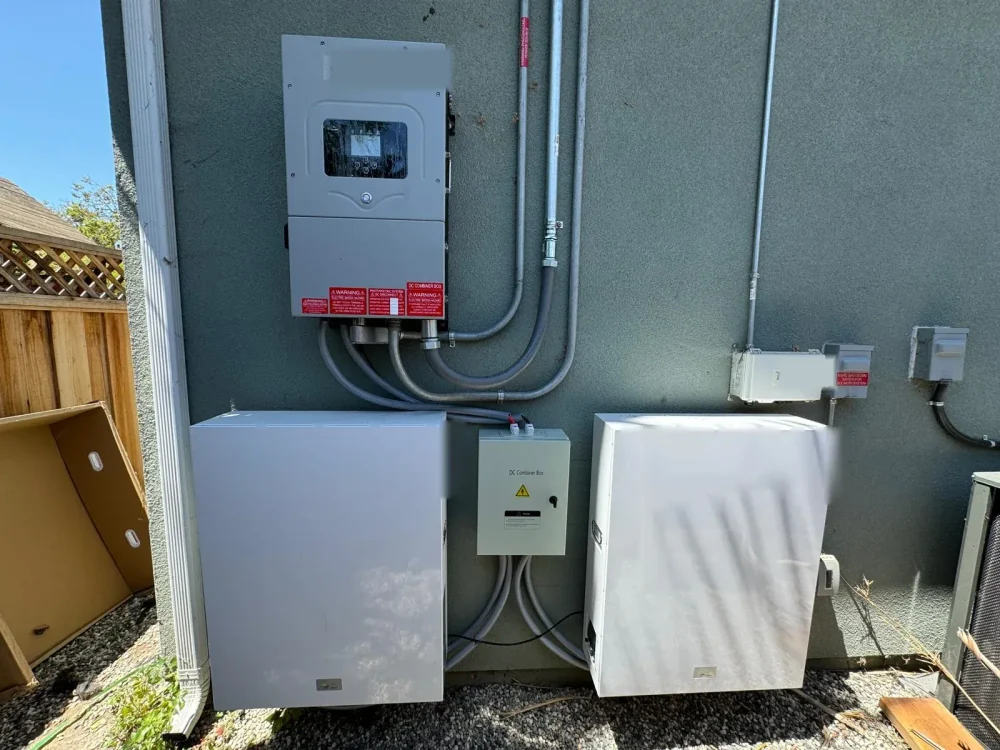 Outdoor wall-mounted battery and inverter installation with conduit routing